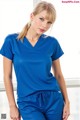 A woman wearing a blue scrub top and pants.